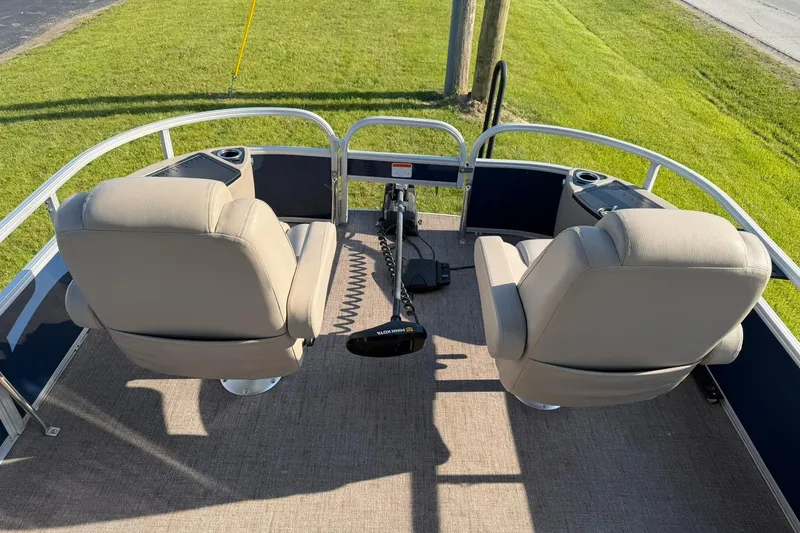 Slide: The Image of 2021 Ranger Reata 223F boat interior with two beige seats and control panel. - 8
