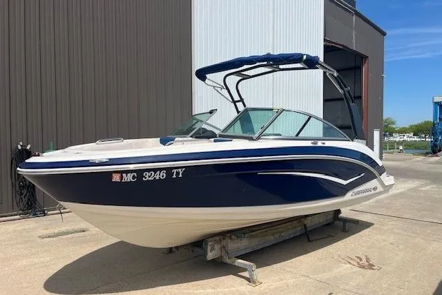 The Image of 2016 Chaparral Vortex 203 VR boat with blue hull, docked outdoors. - 0