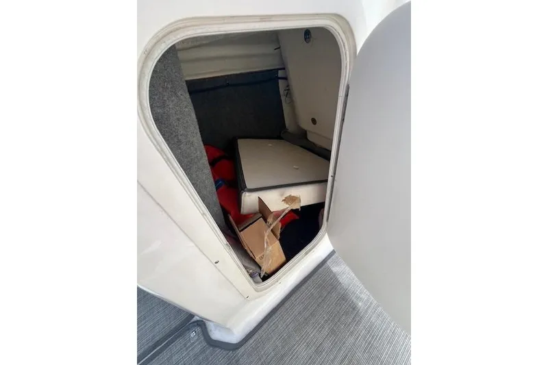 Slide: The Image of Storage compartment of a 2016 Chaparral Vortex 203 VR boat, partially open. - 11