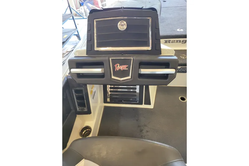 Slide: The Image of 2023 Ranger Z521R boat dashboard with storage compartments and logo. - 19