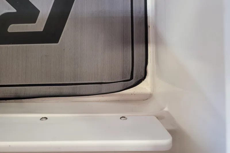 Slide: The Image of 2023 Ranger Z521R boat interior detail with textured panel and white surface. - 22