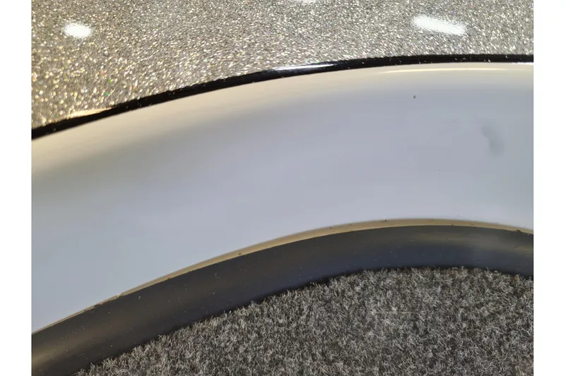 Slide: The Image of Close-up of 2023 Ranger Z521R boat's glittery surface and trim detail. - 25
