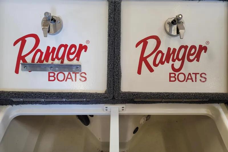 Slide: The Image of 2023 Ranger Z521R boat compartments with red "Ranger Boats" logo and metal latches. - 26