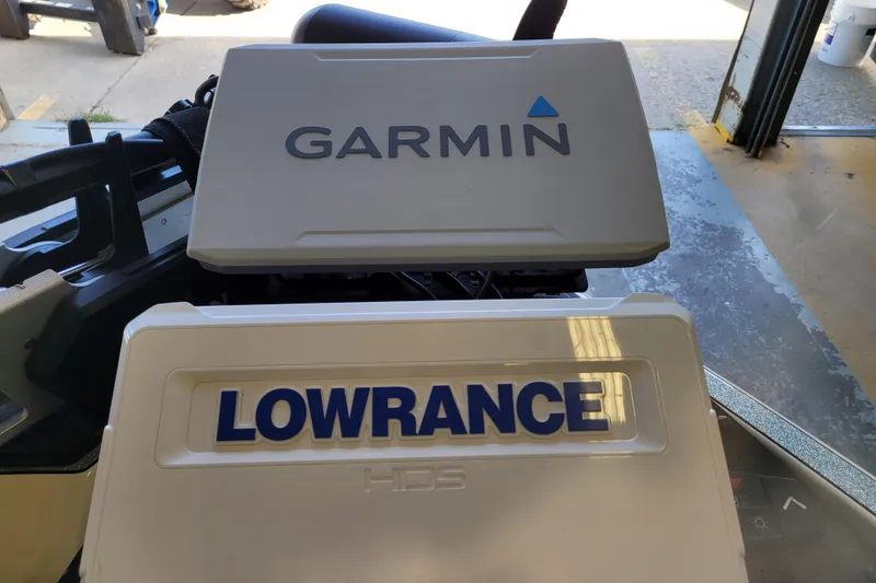 Slide: The Image of 2023 Ranger Z521R boat with Garmin and Lowrance electronics in a garage setting. - 31