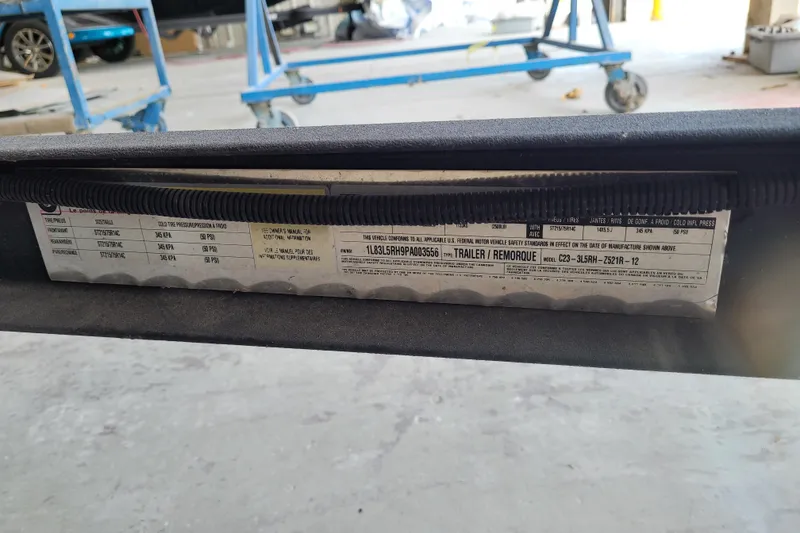 Slide: The Image of 2023 Ranger Z521R trailer label with specifications and safety standards. - 36