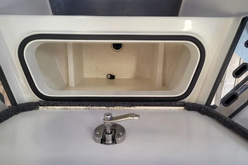 Slide: The Image of 2023 Ranger Z521R storage compartment with latch, open and empty. - 6