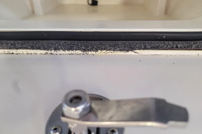 Slide: The Image of Close-up of a 2023 Ranger Z521R boat latch and compartment edge. - 7