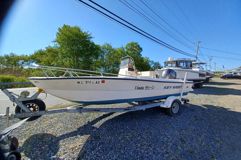 The Image of 2005 Key West 1900 Center Console boat on trailer, parked outdoors. - 1