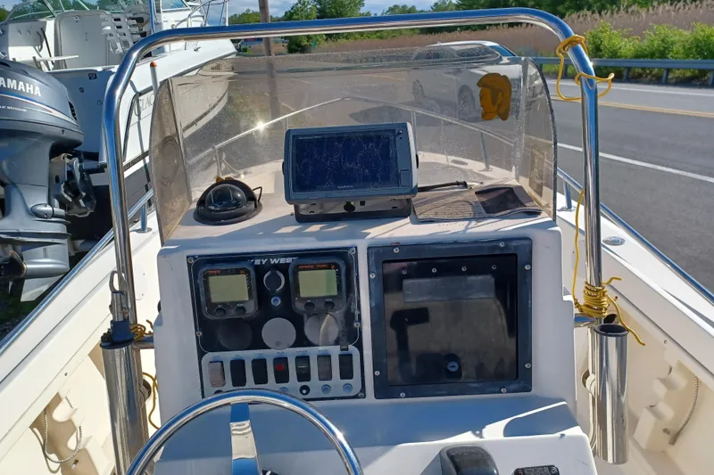 Slide: The Image of Center console of a 2005 Key West 1900 boat with navigation equipment and controls. - 12