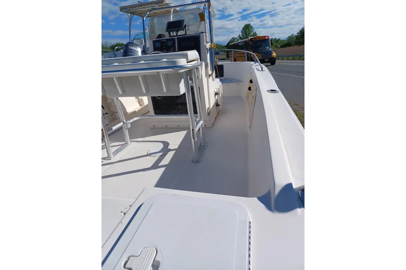 Slide: The Image of 2005 Key West 1900 Center Console boat with Yamaha engine, parked near a road. - 5