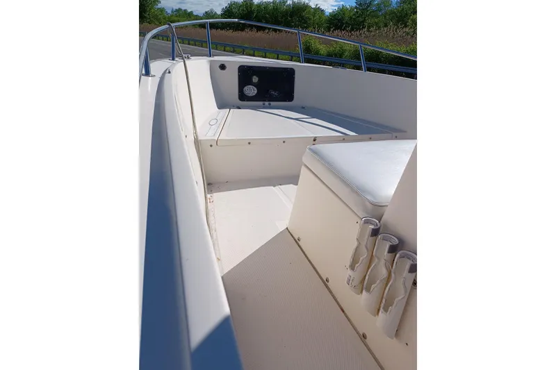 Slide: The Image of 2005 Key West 1900 Center Console boat interior with seating and rod holders. - 7