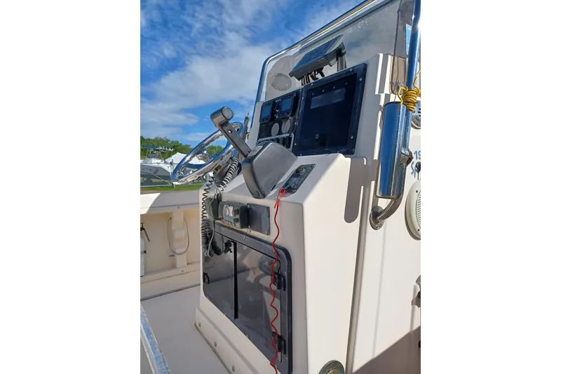 Slide: The Image of Center console of a 2005 Key West 1900 boat with steering wheel and controls. - 9