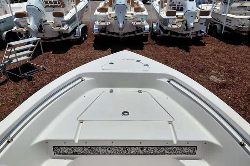 Slide: The Image of 2023 Key West 189 FS boat bow view with multiple boats in background. - 15