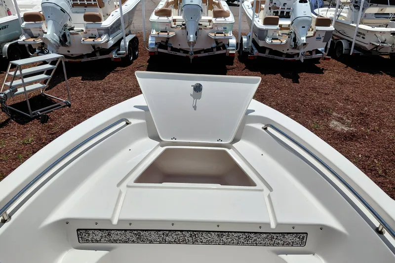 Slide: The Image of 2023 Key West 189 FS boat with open storage compartment, surrounded by other boats. - 16