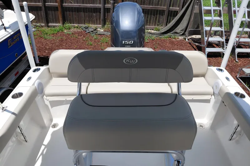 Slide: The Image of 2023 Key West 189 FS boat interior with seating and engine view. - 22