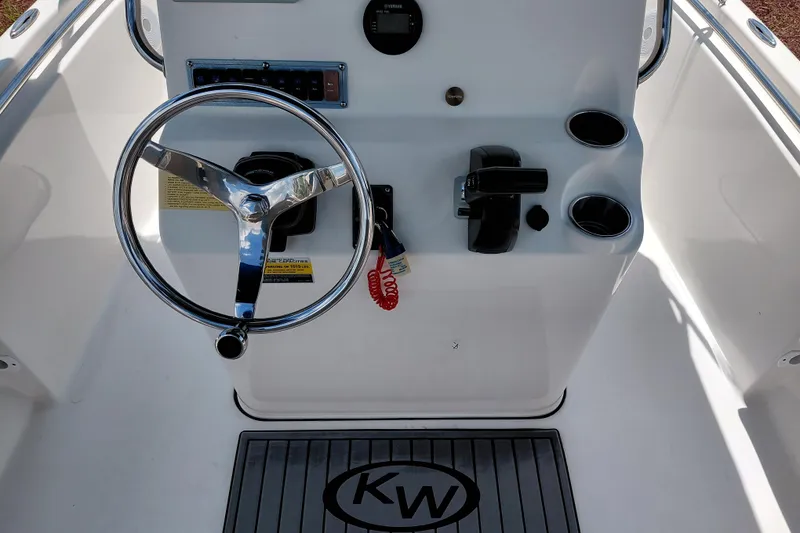 Slide: The Image of 2023 Key West 189 FS boat console with steering wheel and controls. - 23