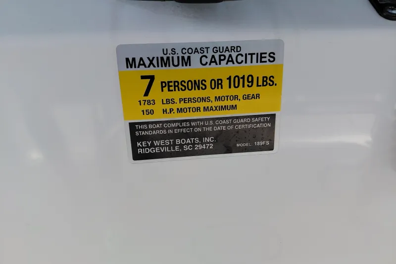 Slide: The Image of 2023 Key West 189 FS boat capacity label, 7 persons or 1019 lbs, U.S. Coast Guard compliant. - 24