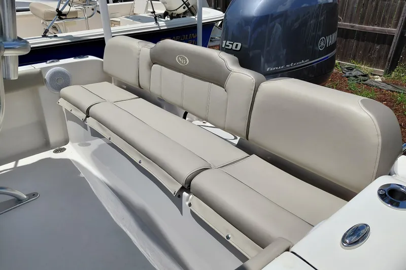 Slide: The Image of 2023 Key West 189 FS boat interior with beige seating and Yamaha engine. - 25