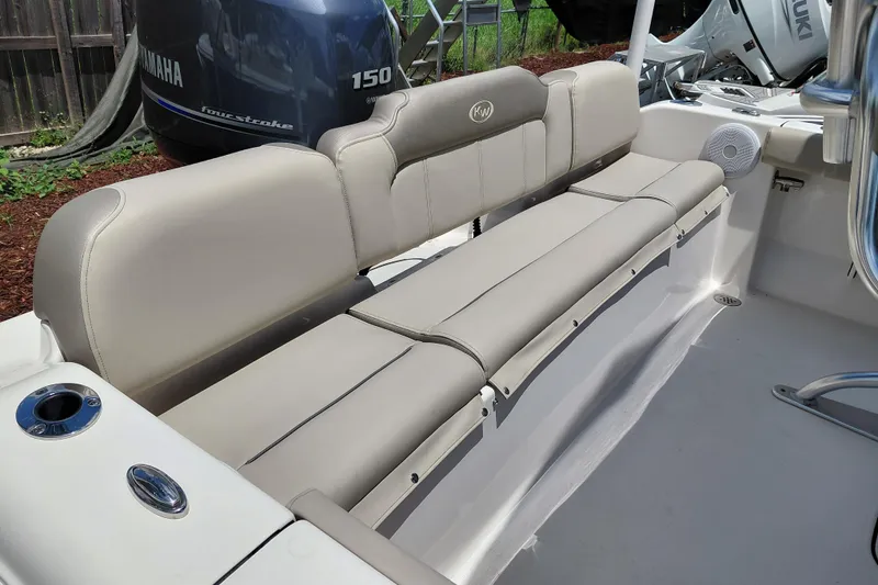Slide: The Image of 2023 Key West 189 FS boat interior with beige seating and Yamaha engine. - 26
