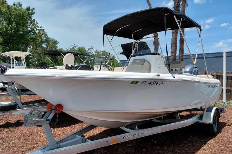 Slide: The Image of 2023 Key West 189 FS boat on trailer, parked outdoors under clear sky. - 3