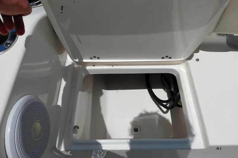 Slide: The Image of Open storage compartment on 2023 Key West 189 FS boat, featuring a speaker and wiring. - 36