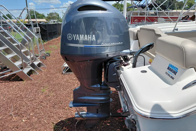 Slide: The Image of 2023 Key West 189 FS boat with Yamaha four-stroke outboard motor displayed outdoors. - 7