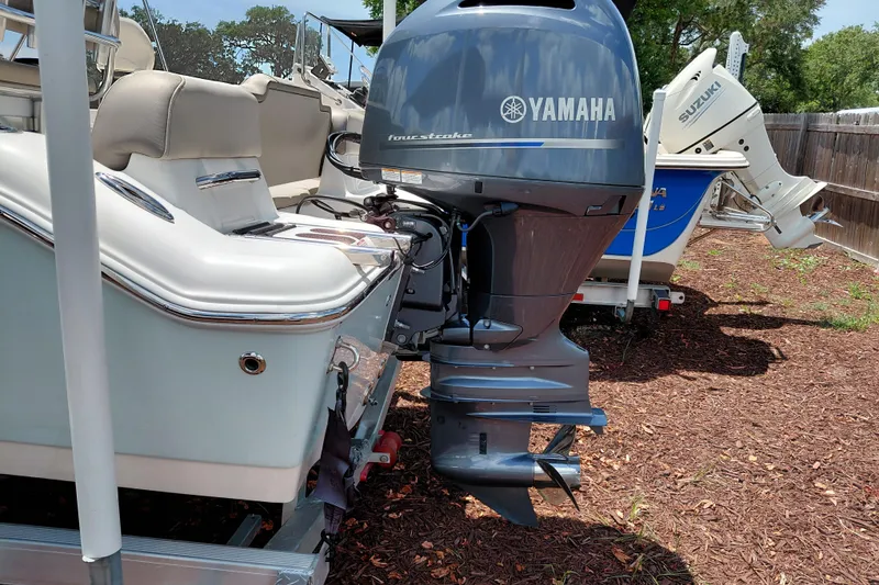 Slide: The Image of 2023 Key West 189 FS boat with Yamaha outboard motor, parked outdoors. - 8