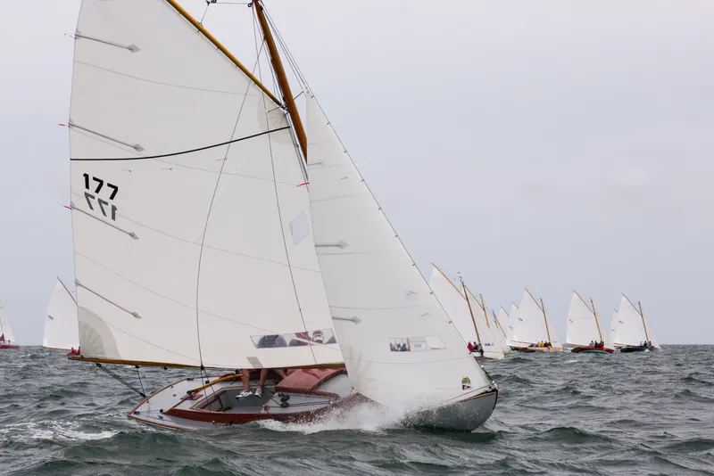 Slide: The Image of Sailboats racing on the ocean, featuring a 1998 Crosby Wianno Senior. - 2