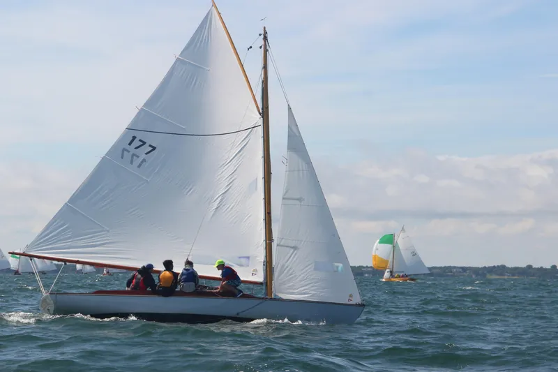 Slide: The Image of Sailboat Crosby Wianno Senior 1998 on open water, crew onboard, clear sky. - 3