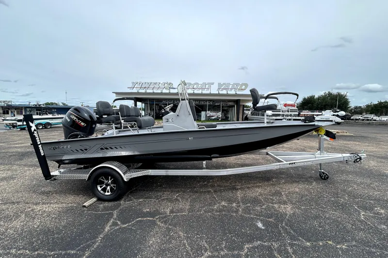 The Image of 2026 Xpress H20B Bay boat on trailer at dealership lot. - 0