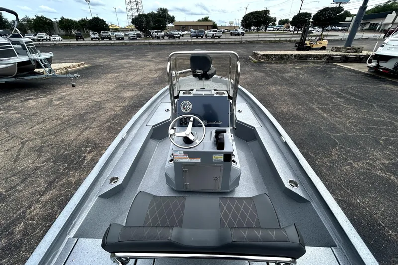 Slide: The Image of 2026 Xpress H20B Bay boat with steering console, parked in a lot. - 10