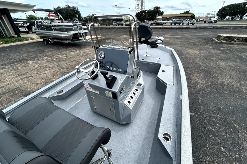 Slide: The Image of 2026 Xpress H20B Bay boat interior with steering console and seating. - 11