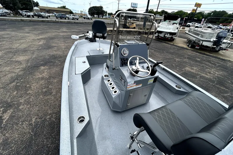 Slide: The Image of 2026 Xpress H20B Bay boat interior with steering console and seating. - 12
