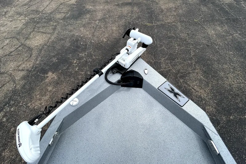Slide: The Image of 2026 Xpress H20B Bay boat with Minn Kota trolling motor on pavement. - 15