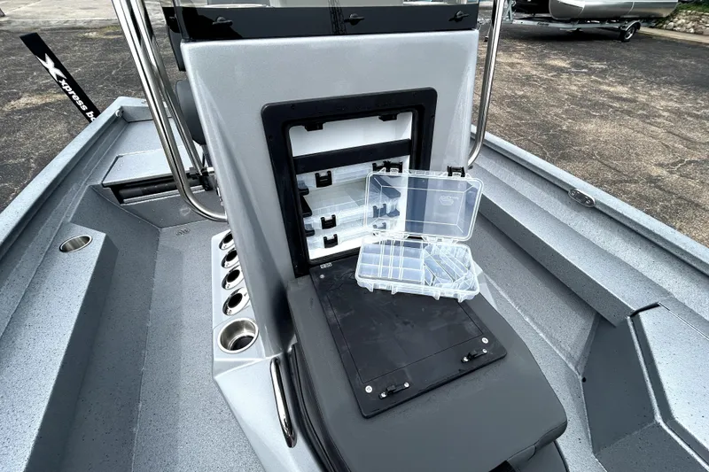 Slide: The Image of 2026 Xpress H20B Bay boat with open storage compartment and tackle box. - 26