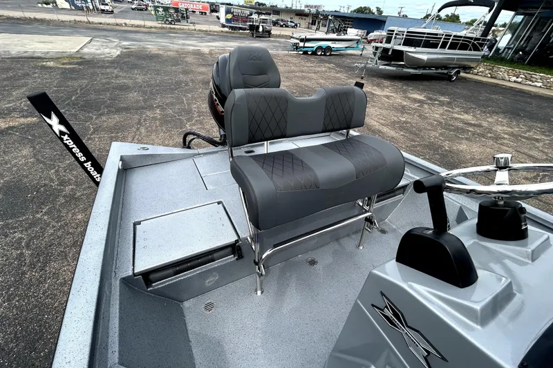 Slide: The Image of 2026 Xpress H20B Bay boat with gray seating and steering console. - 34