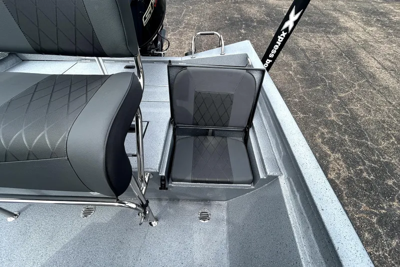 Slide: The Image of 2026 Xpress H20B Bay boat interior with gray seating and textured flooring. - 38