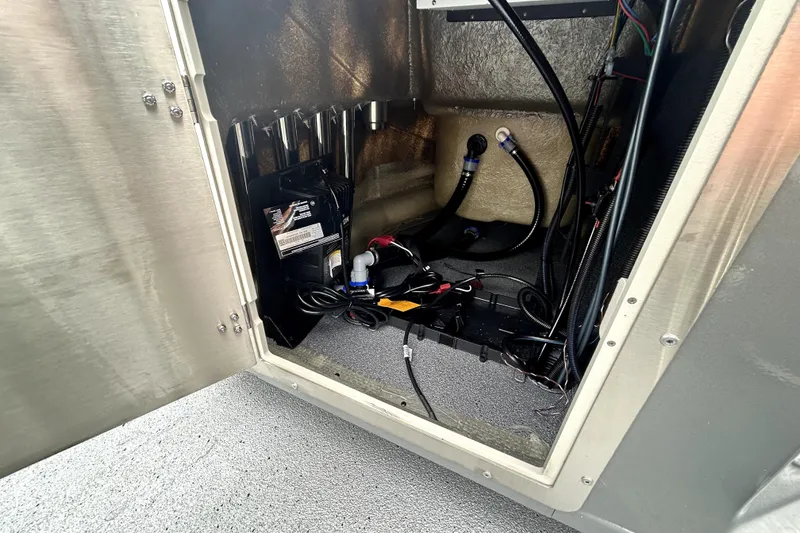 Slide: The Image of 2026 Xpress H20B Bay boat compartment with wiring and battery setup. - 42