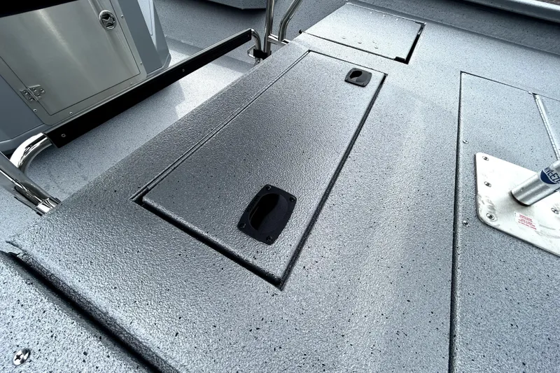 Slide: The Image of 2026 Xpress H20B Bay boat deck with storage compartments and textured surface. - 43