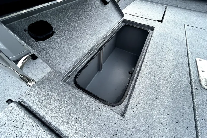 Slide: The Image of Open storage compartment on 2026 Xpress H20B Bay boat deck. - 44