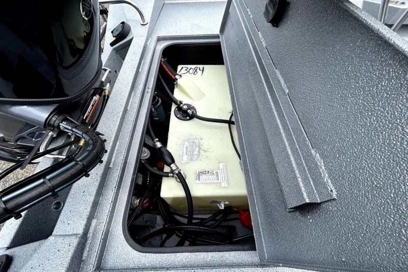 Slide: The Image of Open compartment of 2026 Xpress H20B Bay boat showing internal components and wiring. - 46
