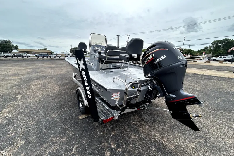 Slide: The Image of 2026 Xpress H20B Bay boat with Yamaha engine, parked on a trailer. - 5