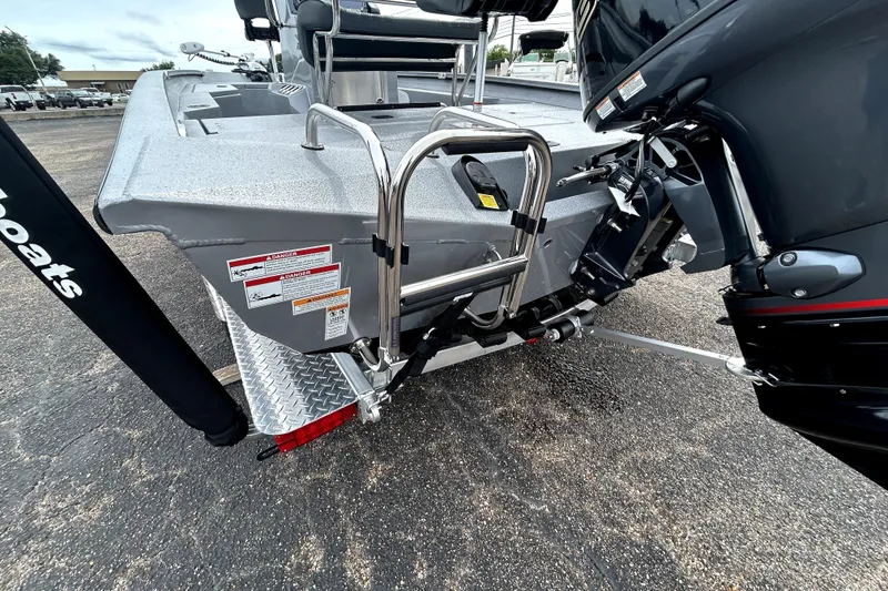 Slide: The Image of 2026 Xpress H20B Bay boat rear view with motor and ladder. - 6