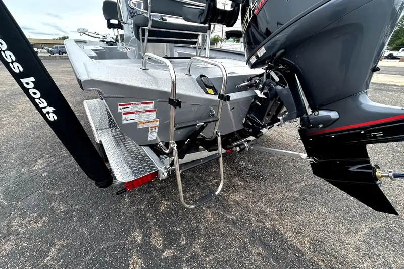 Slide: The Image of 2026 Xpress H20B Bay boat rear view with motor and ladder. - 7