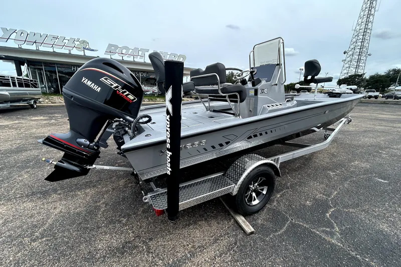 Slide: The Image of 2026 Xpress H20B Bay boat with Yamaha engine on trailer at dealership. - 9