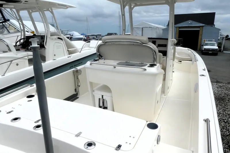 Slide: The Image of 2019 Boston Whaler 270 Dauntless boat interior, showcasing seating and console features. - 14