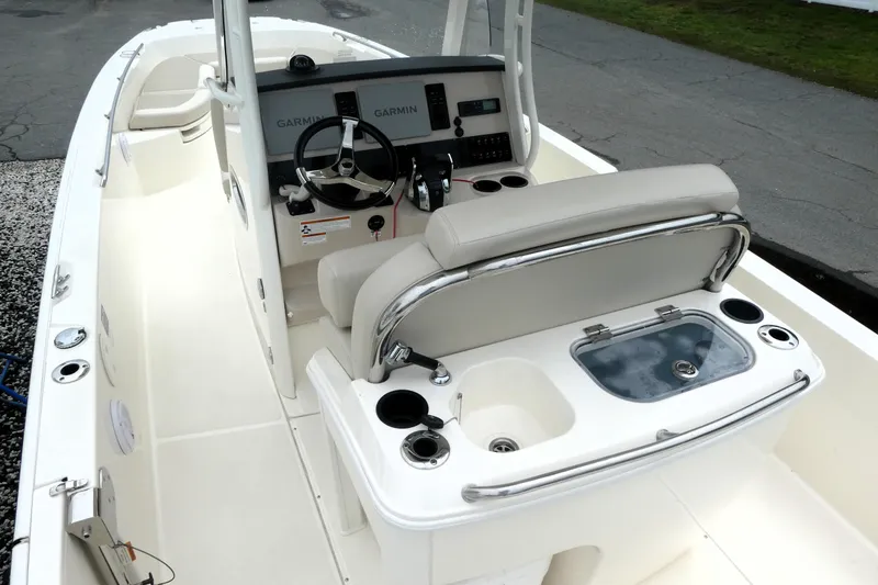 Slide: The Image of 2019 Boston Whaler 270 Dauntless boat interior with helm, seating, and navigation equipment. - 5