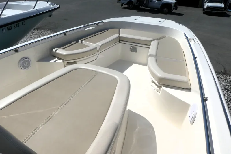 Slide: The Image of 2019 Boston Whaler 270 Dauntless boat interior with cushioned seating and speaker. - 8