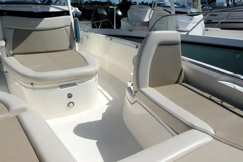 Slide: The Image of 2019 Boston Whaler 270 Dauntless boat interior with beige seating and sleek design. - 9