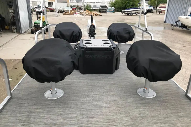 Slide: The Image of 2024 Tigershark 700 12' Mini Pontoon with covered seats and central console. - 11